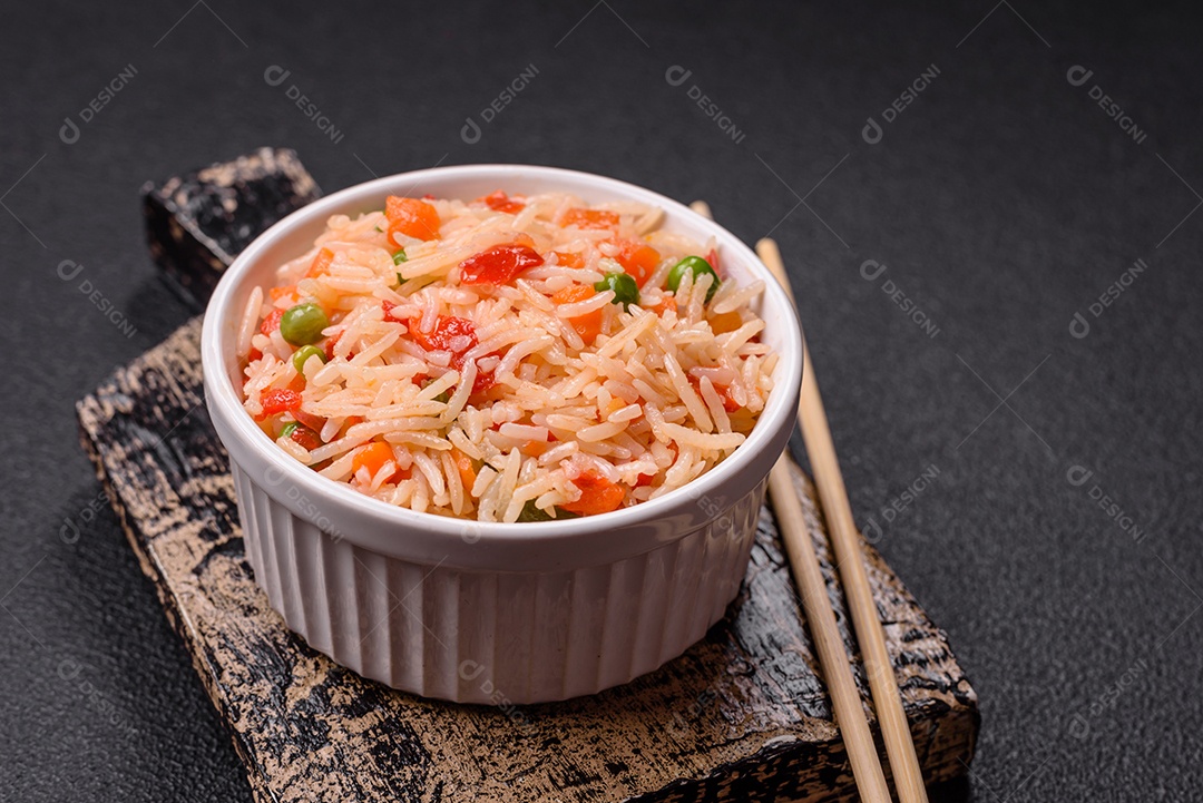 A imagem mostra um prato de arroz cozido com vegetais, como cenoura e vagem