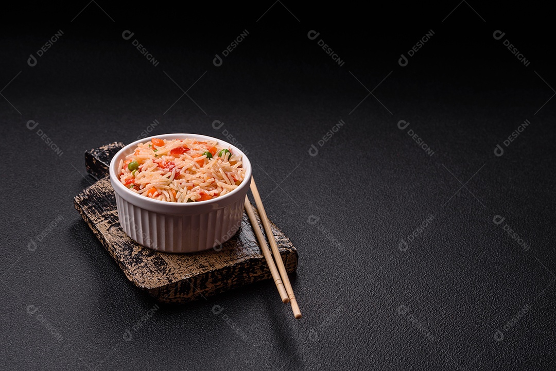 A imagem mostra um prato de arroz cozido com vegetais, como cenoura e vagem