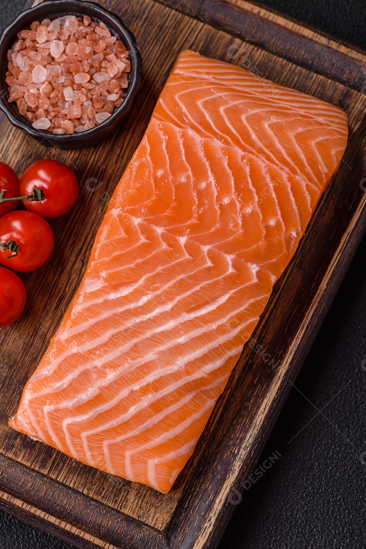 A imagem mostra um filé de salmão cru, pronto para ser preparado, acompanhado de temperos como sal rosa do Himalaia