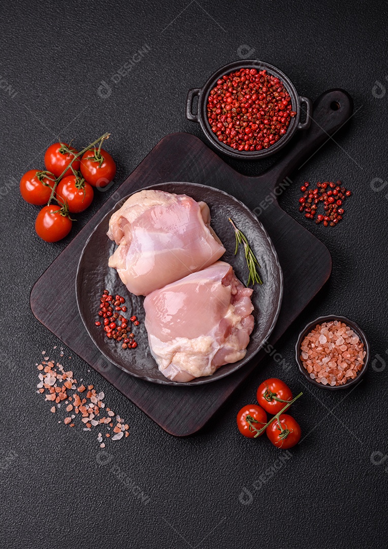 A imagem mostra sobrecoxas de frango cruas em um prato azul. A sobrecoxa é a parte superior da perna do frango