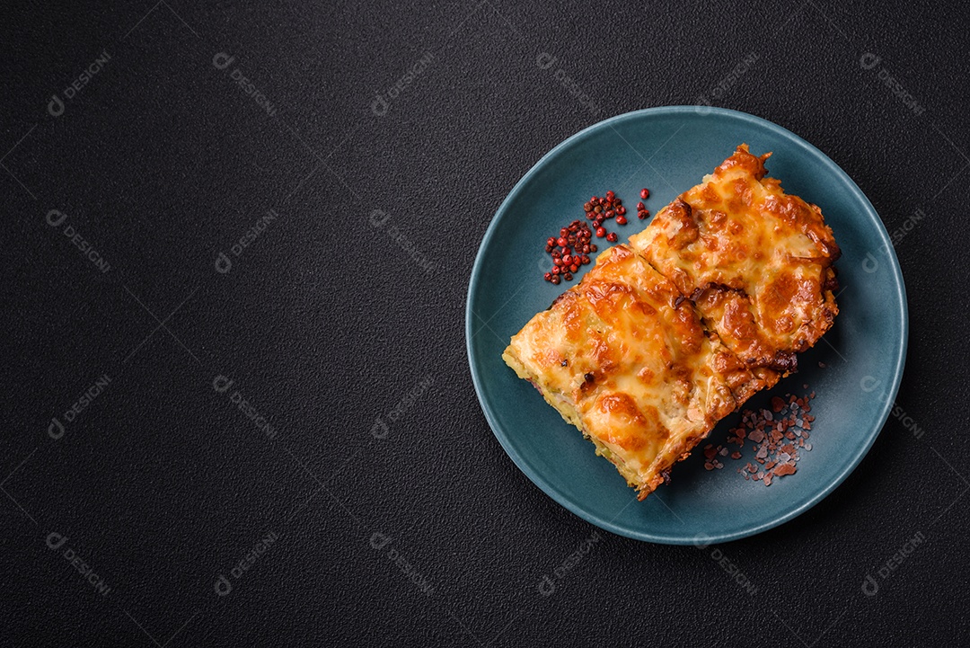 A imagem mostra um prato de lasanha com tomate cereja e pimenta rosa em grão