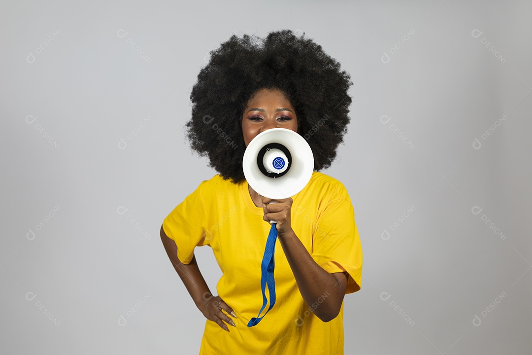 Linda mulher jovem afro morena brasileira segurando megafone sobre fundo isolado